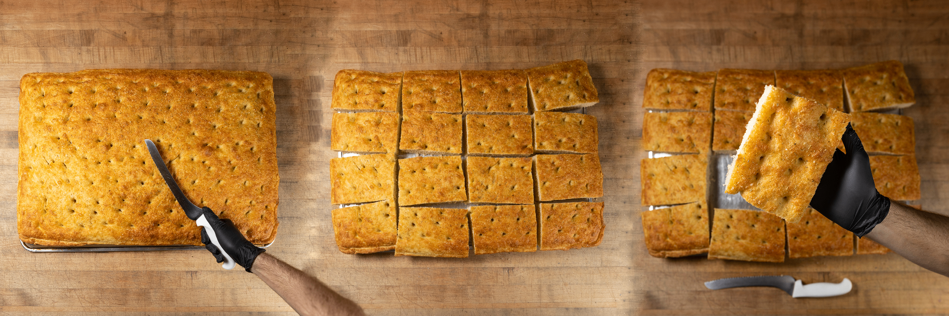 Fresh-baked focaccia trays being sliced by hand