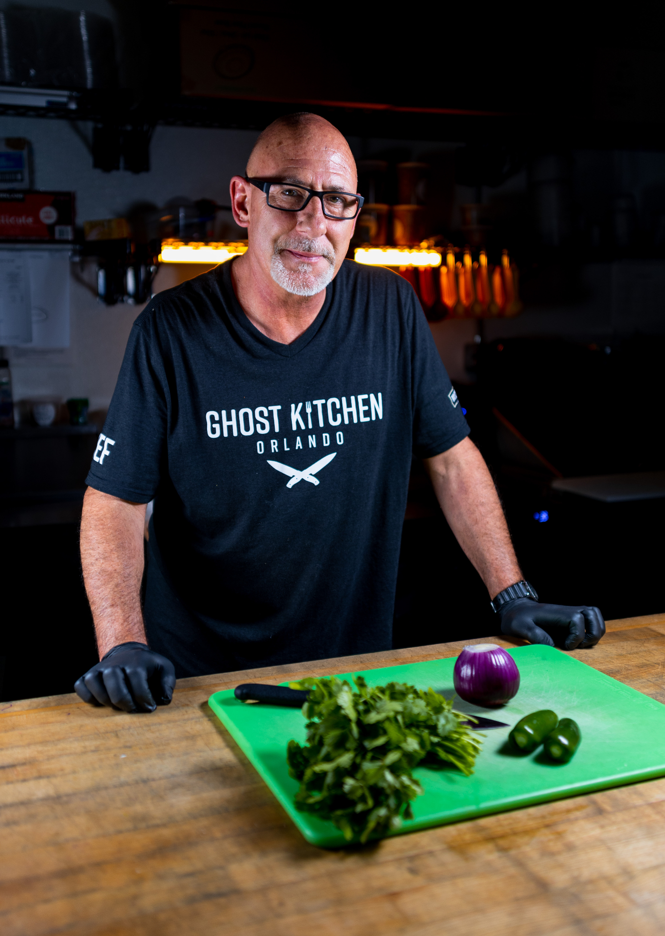 Chef Jay in the kitchen with fresh ingredients on a cutting board