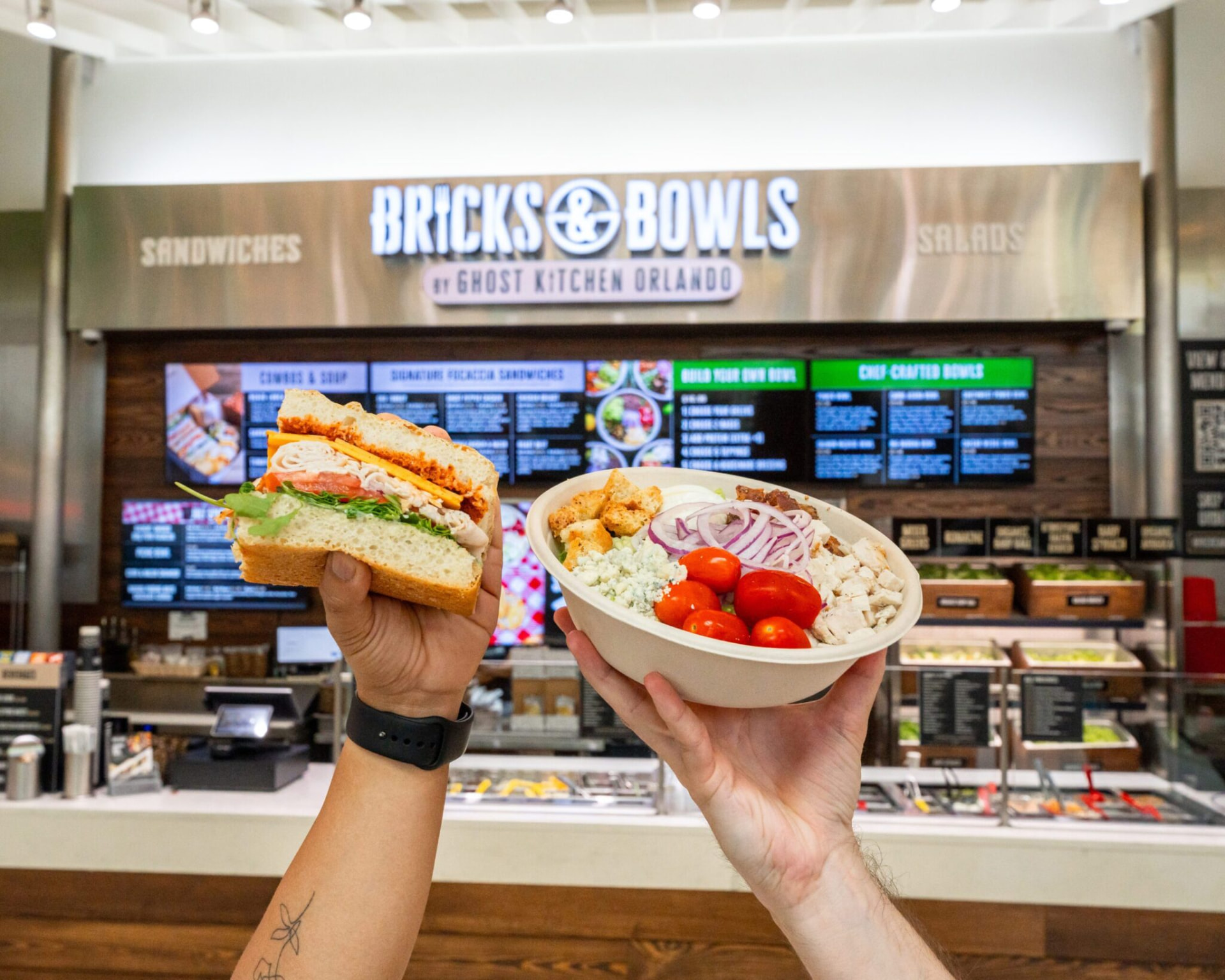 Bricks & Bowls restaurant interior with a focaccia sandwich and superfood bowl